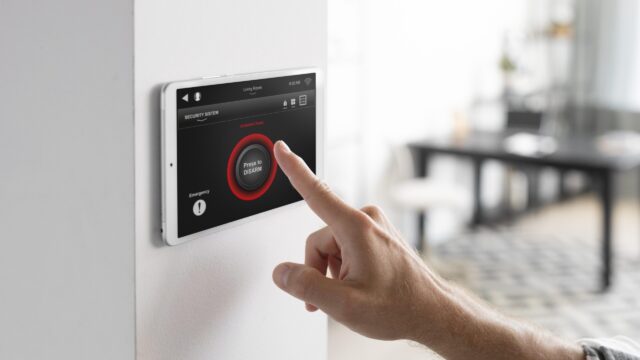 man-using-tablet-his-smart-home-scaled-1